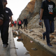 Migrants attempting to reach the U.S. walk along a highway toward the U.S.-Mexico border fence near Tijuana, Mexico.